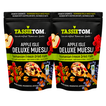 Two packages of Tassie Tom Apple Isle Deluxe Muesli with fruit and muesli imagery on a white background.