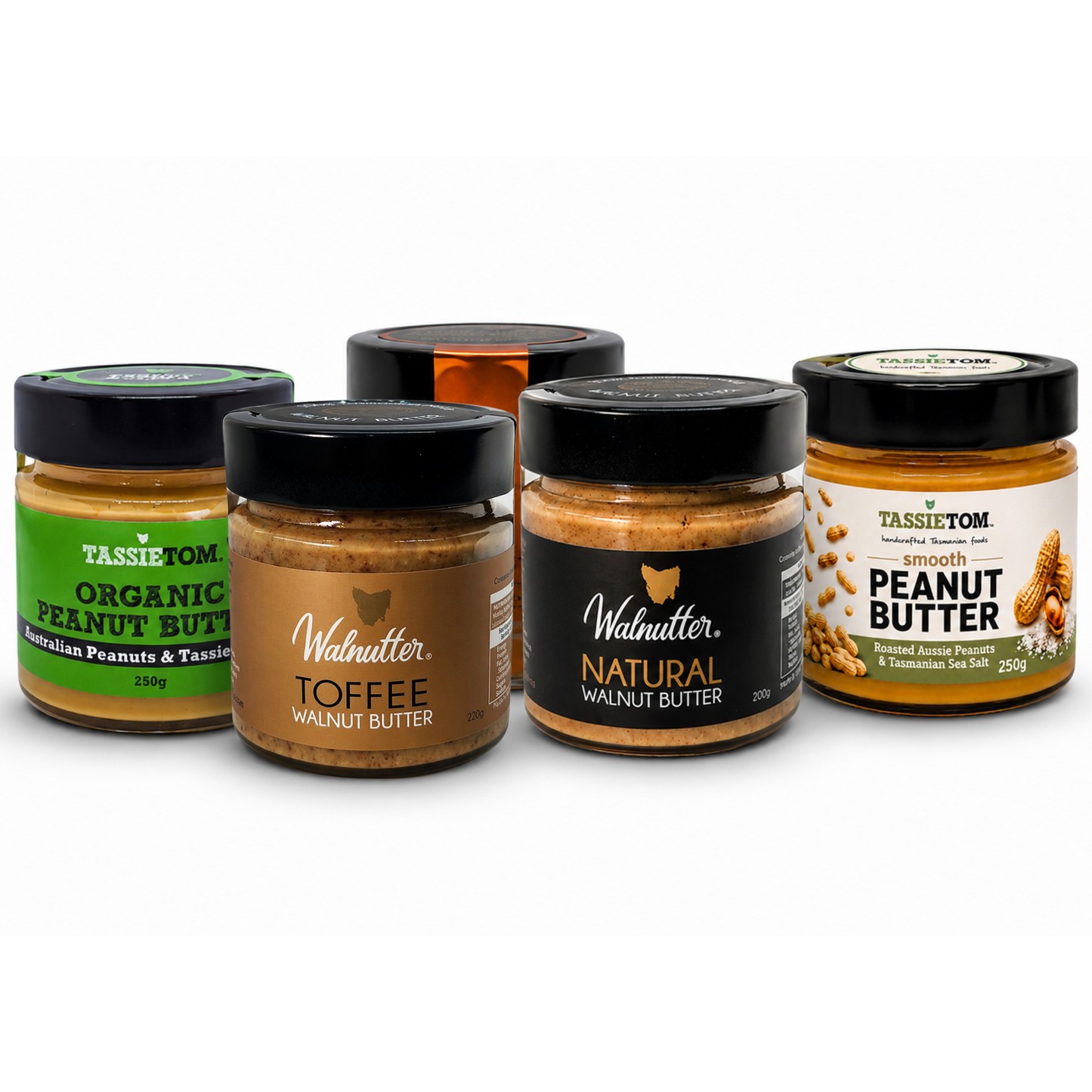 Five jars of different types of nut butter on a white background