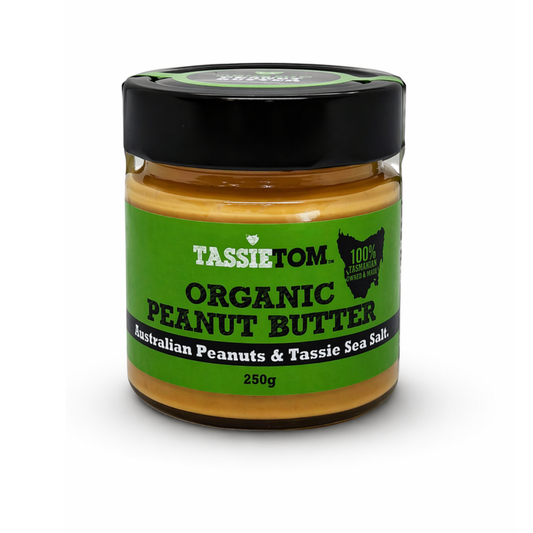 Jar of Tassie Tom organic peanut butter with a green label on a white background
