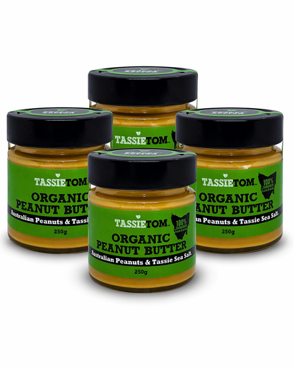 Four jars of TassieTom Organic Peanut Butter on a white background