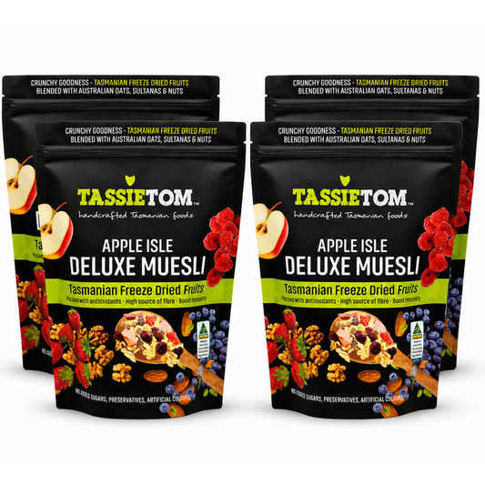 Four packages of Tassie Tom Apple Isle Deluxe Muesli on a white background